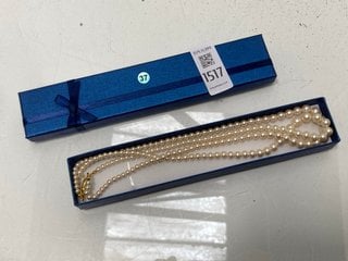 Lot 1517  
            Marchington SR13 - Parcel Delivery Only 

                
A DOUBLE STRING OF VINTAGE FAUX PEARLS WITH A GOLD COLOURED CLASP, BOXED: LOCATIO...
