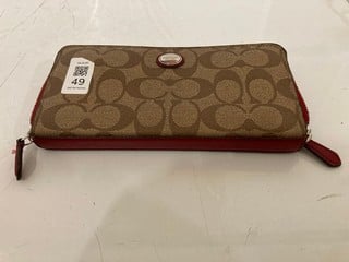 Lot 49  
            Nottingham SR6 - Parcel Delivery 
                
COACH SIGNATURE PRINT PURSE WITH RED DETAIL