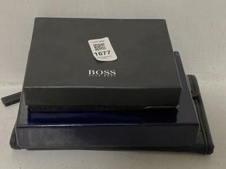 Lot 1677  
            Chesterfield SR44 - Parcel Delivery Only 

                
3 X ASSORTED BRANDED WALLETS TO INCLUDE BOSS AREZZO WALLET IN BLACK (LOCATION: G6)