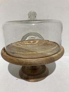 Lot 653  
            Chesterfield SR44 - Parcel Delivery Only 

                
NKUKU RECYCLED GLASS DOME CAKE STAND - MANGO WOOD & GLASS - 35 X 35.5CM (DIA) - I...