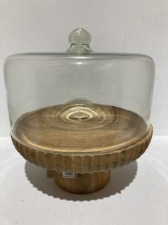 Lot 702  
            Chesterfield SR44 - Parcel Delivery Only 

                
NKUKU RECYCLED GLASS DOME CAKE STAND - MANGO WOOD & GLASS - 35 X 35.5CM (DIA) - I...