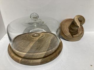 Lot 703  
            Chesterfield SR44 - Parcel Delivery Only 

                
NKUKU RECYCLED GLASS DOME CAKE STAND - MANGO WOOD & GLASS - 35 X 35.5CM (DIA) - I...