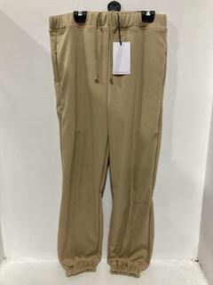 Lot 868  
            Chesterfield SR47 - Parcel Delivery Only 

                
RANDOM IDENTITIES TRACKSUIT BOTTOMS IN BEIGE SIZE S (LOCATION: H4)