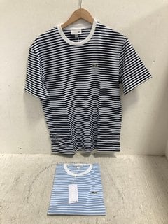 Lot 909  
            Marchington SR14 - Parcel Delivery Only 
                
2 X LACOSTE S/S STRIPED T-SHIRTS IN NAVY/BLUE - SIZE 4: LOCATION - G2