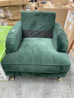 Lot 116  
            Marchington SR18 - Delivery or Collection 
                
GREEN VELVET SNUGGLE CHAIR WITH WOODEN LEGS AND BRASS CASTERS: LOCATION - A6