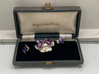 Lot 1065  
            Marchington SR13 - Parcel Delivery Only 

                
AN ANTIQUE ROYAL CRON DERBY HAND PAINTED BONE CHINA FLORAL BROOCH AND MATCHING EA...