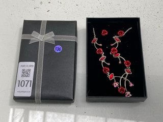 Lot 1071  
            Marchington SR13 - Parcel Delivery Only 

                
A SILVER COLOURED ROSE NECKLACE SET WITH RED STONES AND A PAIR OF MATCHING EARRIN...