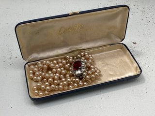 Lot 1099  
            Marchington SR13 - Parcel Delivery Only 

                
A TRIPLE STRAND OF LETOILE VINTAGE SIMULATED PEARLS, BOXED: LOCATION - F2