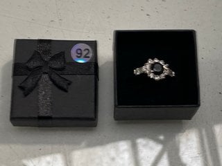 Lot 1207  
            Marchington SR13 - Parcel Delivery Only 

                
A HALLMARKED SILVER RING SET WITH CLEAR STONES AND A LARGE BLACK STONE, BOXED: LO...