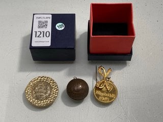 Lot 1210  
            Marchington SR13 - Parcel Delivery Only 

                
A 1953 CORONATION OF QEII BROOCH AND TWO OTHER VINTAGE COIN PENDANTS, BOXED: LOCA...