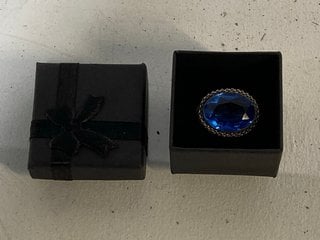 Lot 1370  
            Marchington SR13 - Parcel Delivery Only 

                
AN ANTIQUE BROOCH, A LARGE BLUE STONE IN A SILVER COLOURED MOUNT, BOXED: LOCATION...
