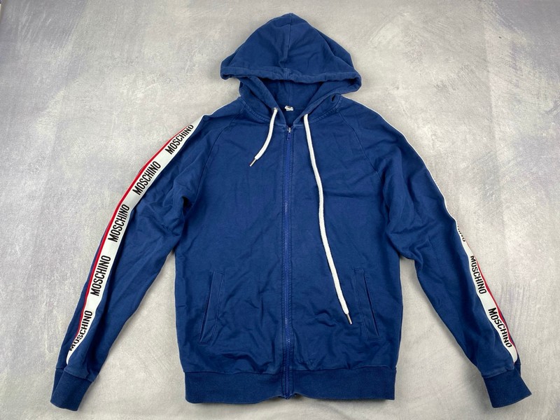 Lot 145  
            Nottingham Luxury Room - Delivery Only 

                
Moschino Hoodie - Size M (VAT ONLY PAYABLE ON BUYERS PREMIUM)