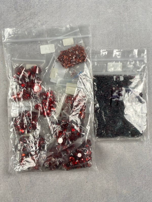 Lot 249  
            Nottingham Luxury Room - Delivery Only 

                
Three Bags of Red Stones, mixed Shapes and Sizes, approx. 0.74Kg (VAT ONLY PAYABL...