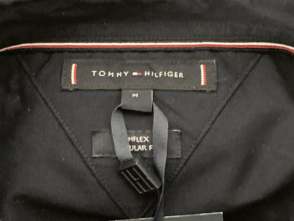 Lot 663  
            Chesterfield SR46 - Parcel Delivery Only 

                
TOMMY HILFIGER COE FLEX SHIRT IN NAVY - UK SIZE M TO INCLUDE TOMMY HILFIGER STRET... - Image 4