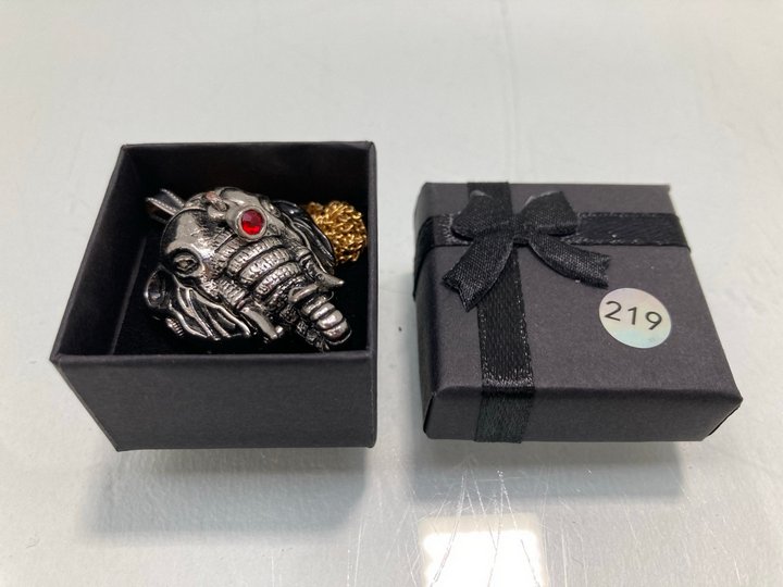 Lot 1462  
            Marchington SR13 - Parcel Delivery Only 

                
A PENDANT WATCH IN THE FORM OF AN ELEPHANTS HEAD SET WITH A RED STONE AND A GOLD ...