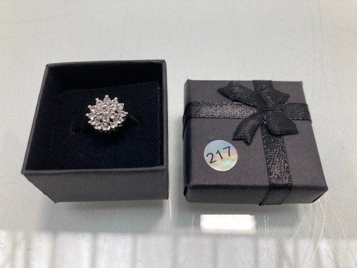 Lot 1467  
            Marchington SR13 - Parcel Delivery Only 

                
A GOLD COLOURED RING SET WITH CLEAR STONES, WITH BOX: LOCATION - F10