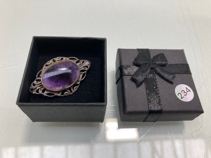 Lot 1476  
            Marchington SR13 - Parcel Delivery Only 

                
AN ANTIQUE HALLMARKED .925 SILVER BROOCH SET WITH A PURPLE STONE, WITH BOX: LOCAT...