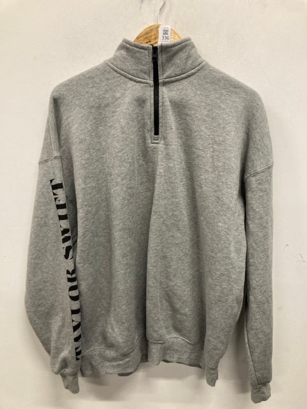 Lot 336  
            Nottingham SR9 - Delivery Only 

                
TAYLOR SWIFT THE ERAS TOUR GREY GRAPHIC 1/4 ZIP UK SIZE S