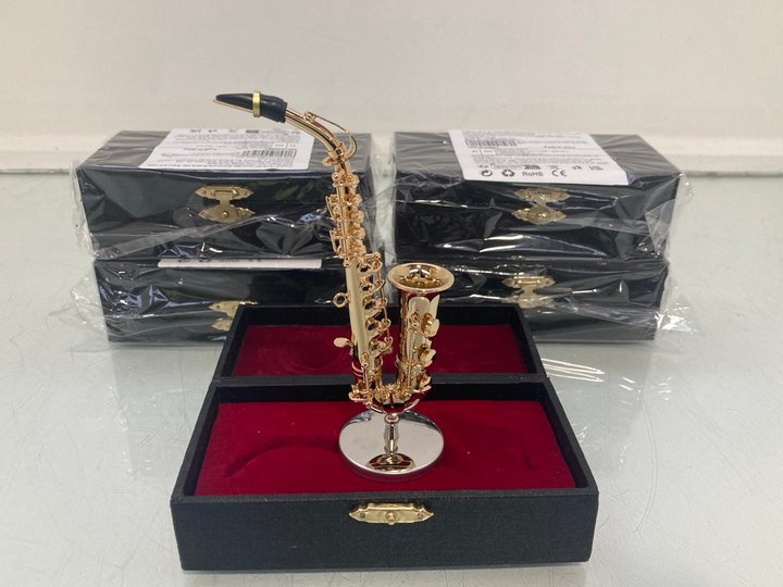 Lot 1338  
            Marchington SR14 - Parcel Delivery Only 

                
5 X MINIATURE ALTO SAXOPHONE GOLD PLATED REPLICAS WITH STAND & CASE: LOCATION - D15
