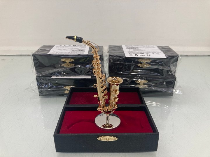 Lot 1339  
            Marchington SR14 - Parcel Delivery Only 

                
5 X MINIATURE ALTO SAXOPHONE GOLD PLATED REPLICAS WITH STAND & CASE: LOCATION - D15