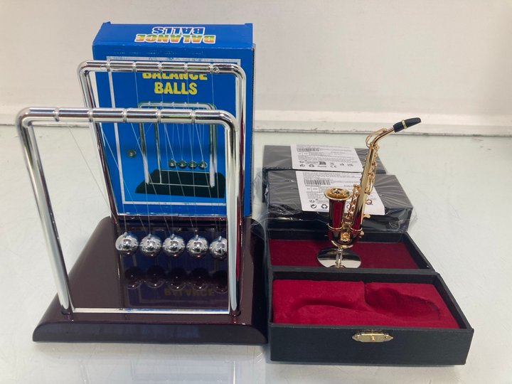 Lot 1347  
            Marchington SR14 - Parcel Delivery Only 

                
3 X MINIATURE ALTO SAXOPHONE GOLD PLATED REPLICAS WITH STAND & CASE TO INCLUDE 2 ...