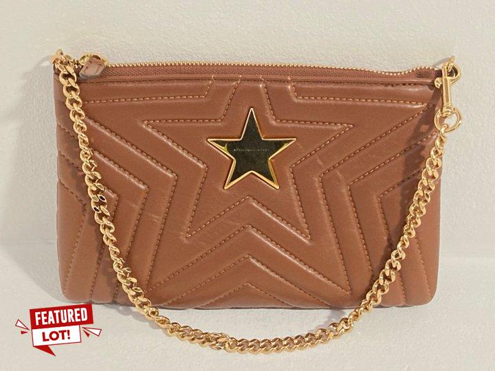 Lot 29  
            Marchington SR12 - Parcel Delivery Only 

                
STELLA MCCARTNEY STELLA STAR HANDBAG IN FAUX LEATHER TAN WITH GOLD TONES: LOCATIO...