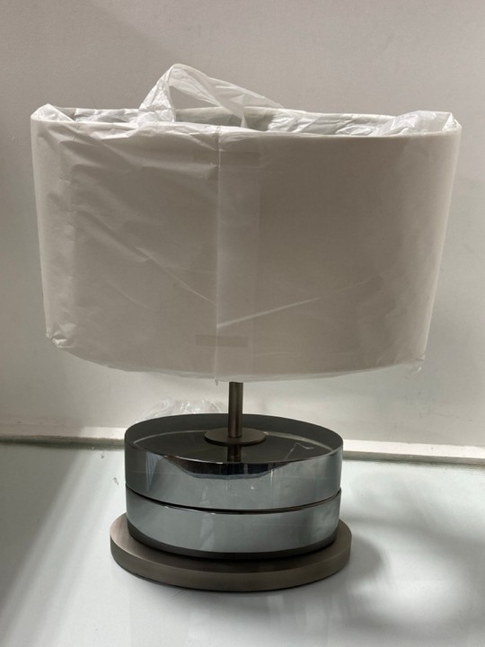 Lot 1015  
            Marchington SR11 - Parcel Delivery Only 

                
TODD TABLE LAMP IN SMOKED FINISH WITH NATURAL SHADE - ORIGINAL RRP £460: LOCATION...