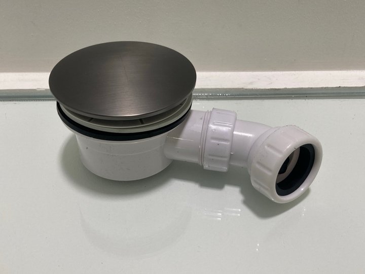 Lot 612  
            Marchington SR19 - Delivery or Collection 

                
90MM FAST FLOW SHOWER WASTE IN GUN METAL WITH OUTLET ELBOW - ORIGINAL RRP £95: LO...