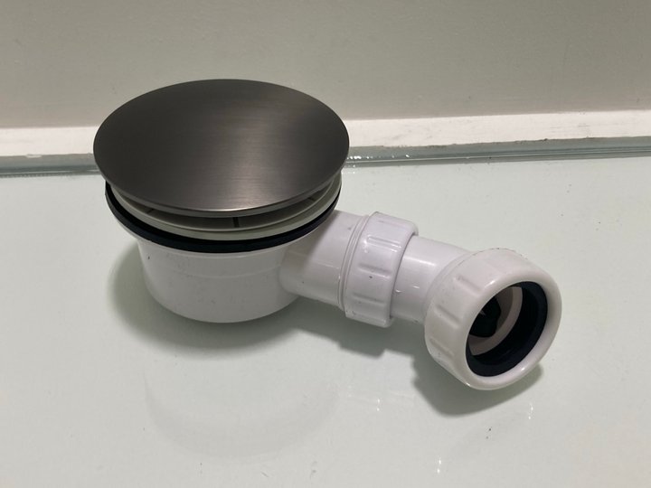 Lot 613  
            Marchington SR19 - Delivery or Collection 

                
90MM FAST FLOW SHOWER WASTE IN GUN METAL WITH OUTLET ELBOW - ORIGINAL RRP £95: LO...