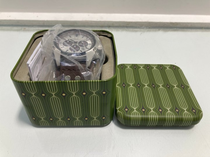 Lot 179  
            Marchington SR13 - Parcel Delivery Only 

                
FOSSIL COACHMAN MENS QUARTZ WATCH WITH LEATHER STRAP IN BROWN -ORIGINAL RRP £147....