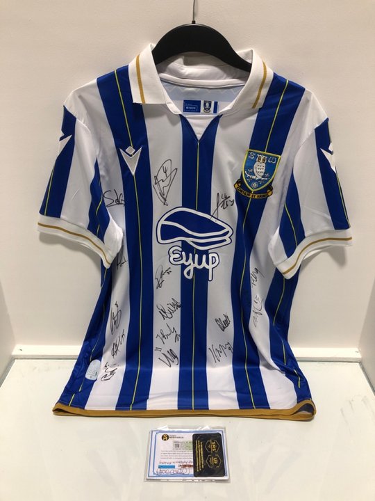 Lot 679  
            Marchington SR13 - Parcel Delivery Only 

                
SIGNED SHEFFIELD WEDNESDAY FOOTBALL SHIRT WITH CERTIFICATE OF AUTHENTICITY-UK SIZ...