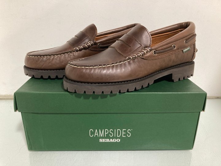 Lot 454  
            Marchington SR13 - Parcel Delivery Only 

                
MENS CAMPSIDES SEBAGO ACADIA MOCASSIN IN TOTAL DARK BROWN - UK SIZE: 10 - ORIGINA...