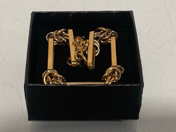 Lot 545  
            Marchington SR13 - Parcel Delivery Only 

                
A LONG LINK GOLD COLOURED BRACELET, WITH BOX: LOCATION - H1