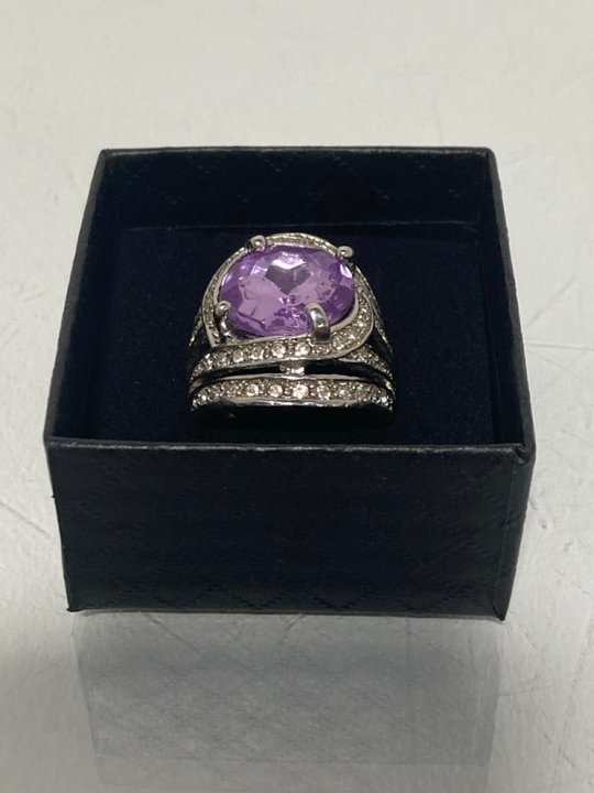 Lot 548  
            Marchington SR13 - Parcel Delivery Only 

                
A HEAVY SILVER COLOURED RING SET WITH CLEAR STONES AND A LARGE PURPLE STONE, WITH...