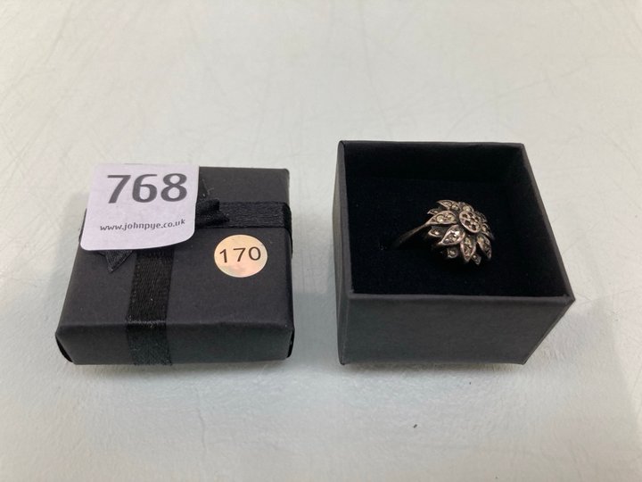 Lot 768  
            Marchington SR13 - Parcel Delivery Only 

                
AN ANTIQUE GOLD COLOURED RING, WITH BOX: LOCATION - G11