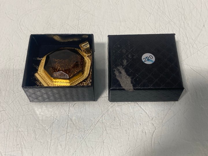 Lot 899  
            Marchington SR13 - Parcel Delivery Only 

                
A VINTAGE AMBER COLOURED PENDANT IN A GOLD COLOURED SETTING WITH CHAIN, WITH BOX:...