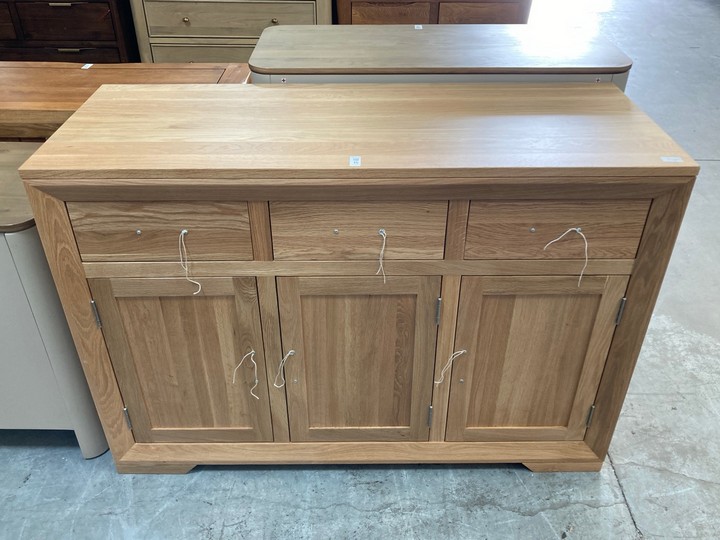 Lot 15  
            Marchington SR10 - Delivery or Collection 

                
OAK FURNITURELAND BEVEL NATURAL SOLID OAK LARGE SIDEBOARD - ORIGINAL RRP £629.99:...