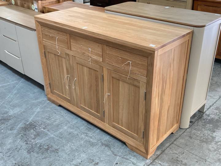 Lot 15  
            Marchington SR10 - Delivery or Collection 

                
OAK FURNITURELAND BEVEL NATURAL SOLID OAK LARGE SIDEBOARD - ORIGINAL RRP £629.99:...