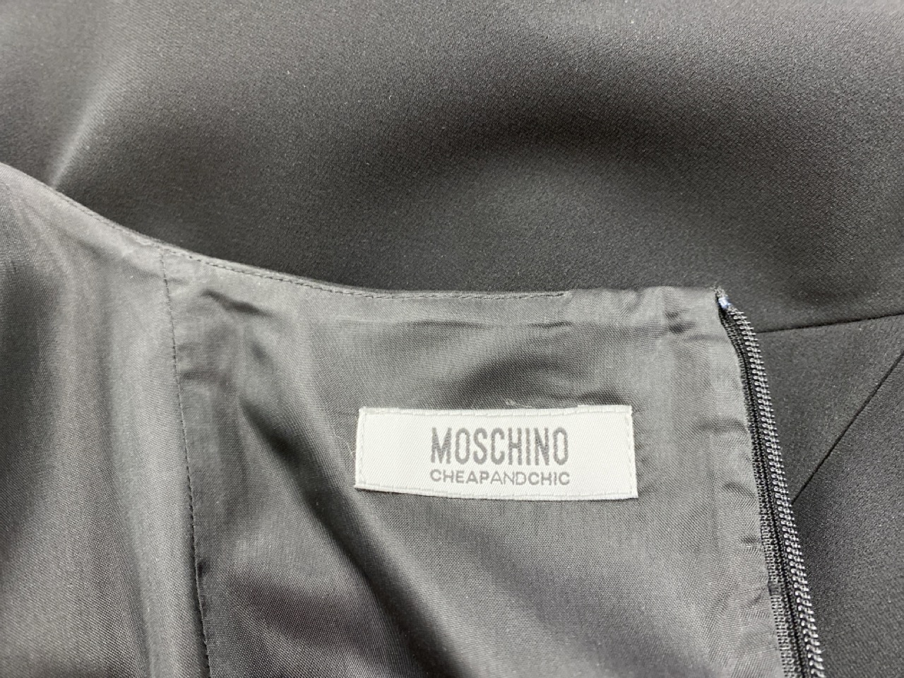 Lot 164  
            Edinburgh SR20 - Delivery Only 

                
MOSCHINO SQUARE NECK MINI DRESS IN BLACK POLYESTER SIZE UK 14: LOCATION - RAIL 2