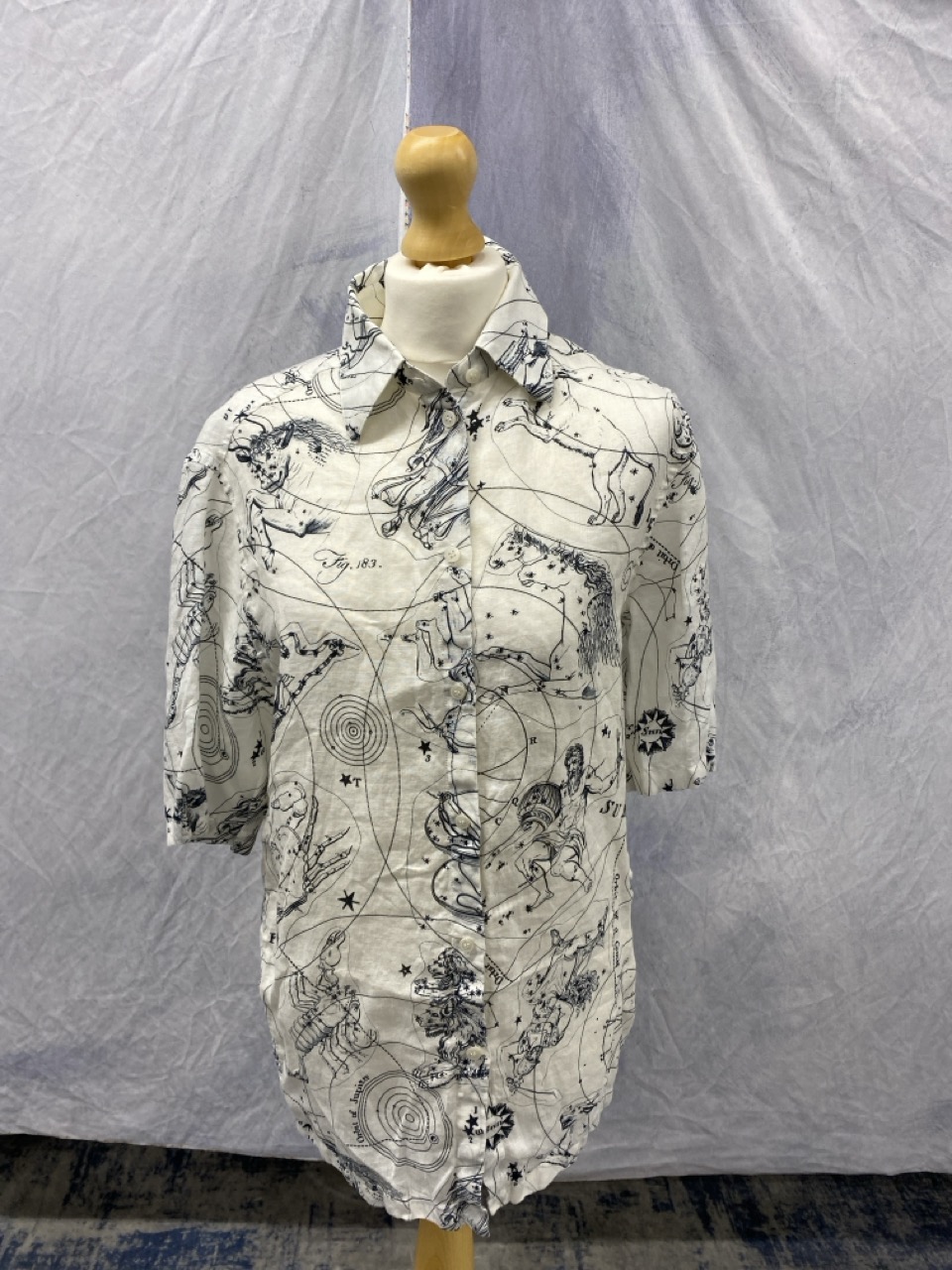 Lot 174  
            Edinburgh SR20 - Delivery Only 

                
ACNE STUDIOS ZODIAC PRINTED SHORT SLEEVE BUTTON FRONT SHIRT IN WHITE AND BLACK LI...