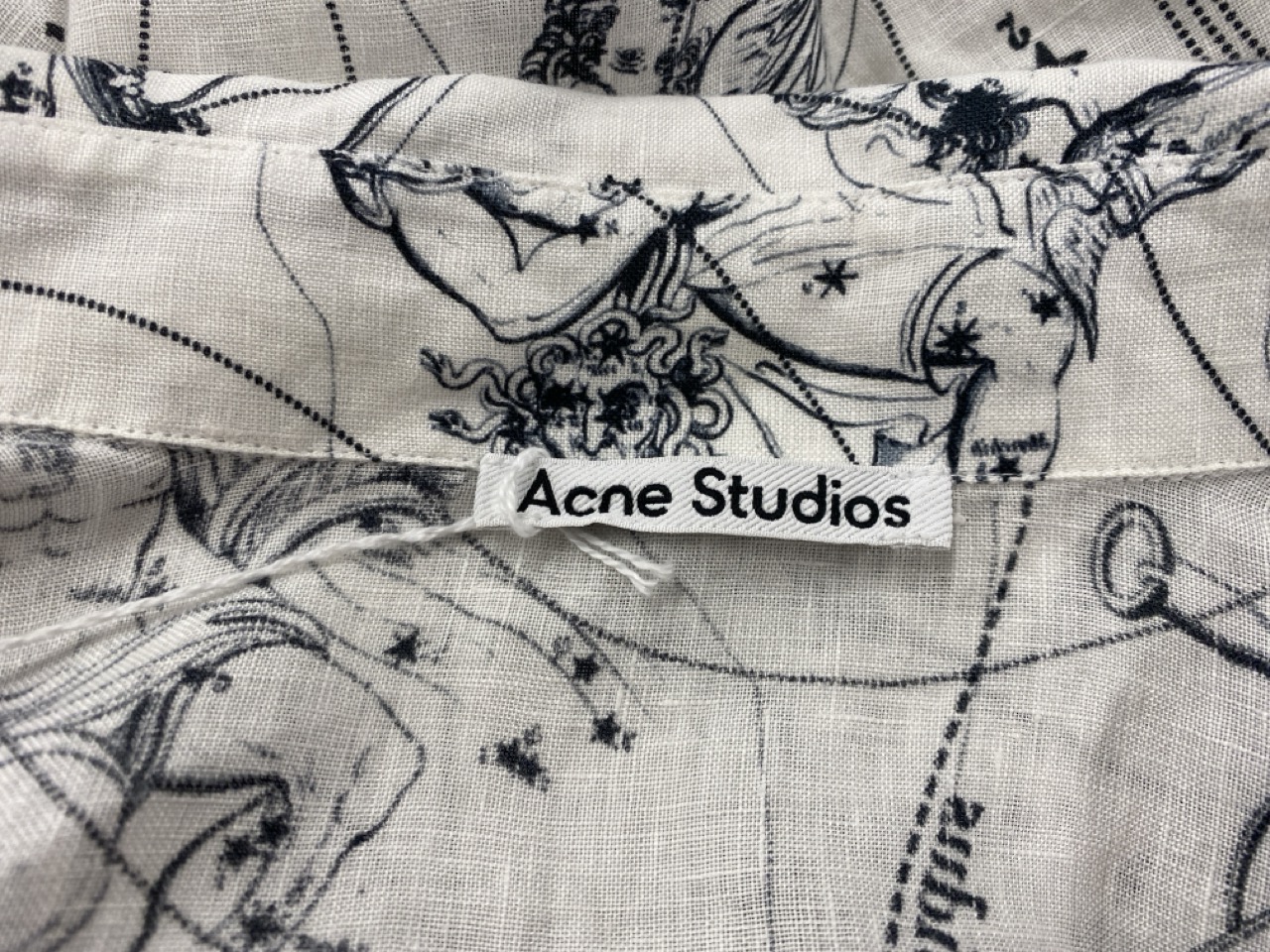 Lot 174  
            Edinburgh SR20 - Delivery Only 

                
ACNE STUDIOS ZODIAC PRINTED SHORT SLEEVE BUTTON FRONT SHIRT IN WHITE AND BLACK LI...