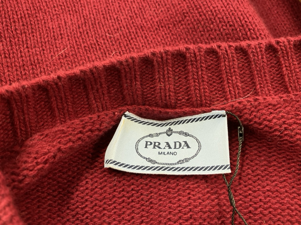 Lot 175  
            Edinburgh SR20 - Delivery Only 

                
PRADA ELBOW PATCH V-NECK SWEATER IN BURGUNDY WOOL SIZE 40: LOCATION - RAIL 2
