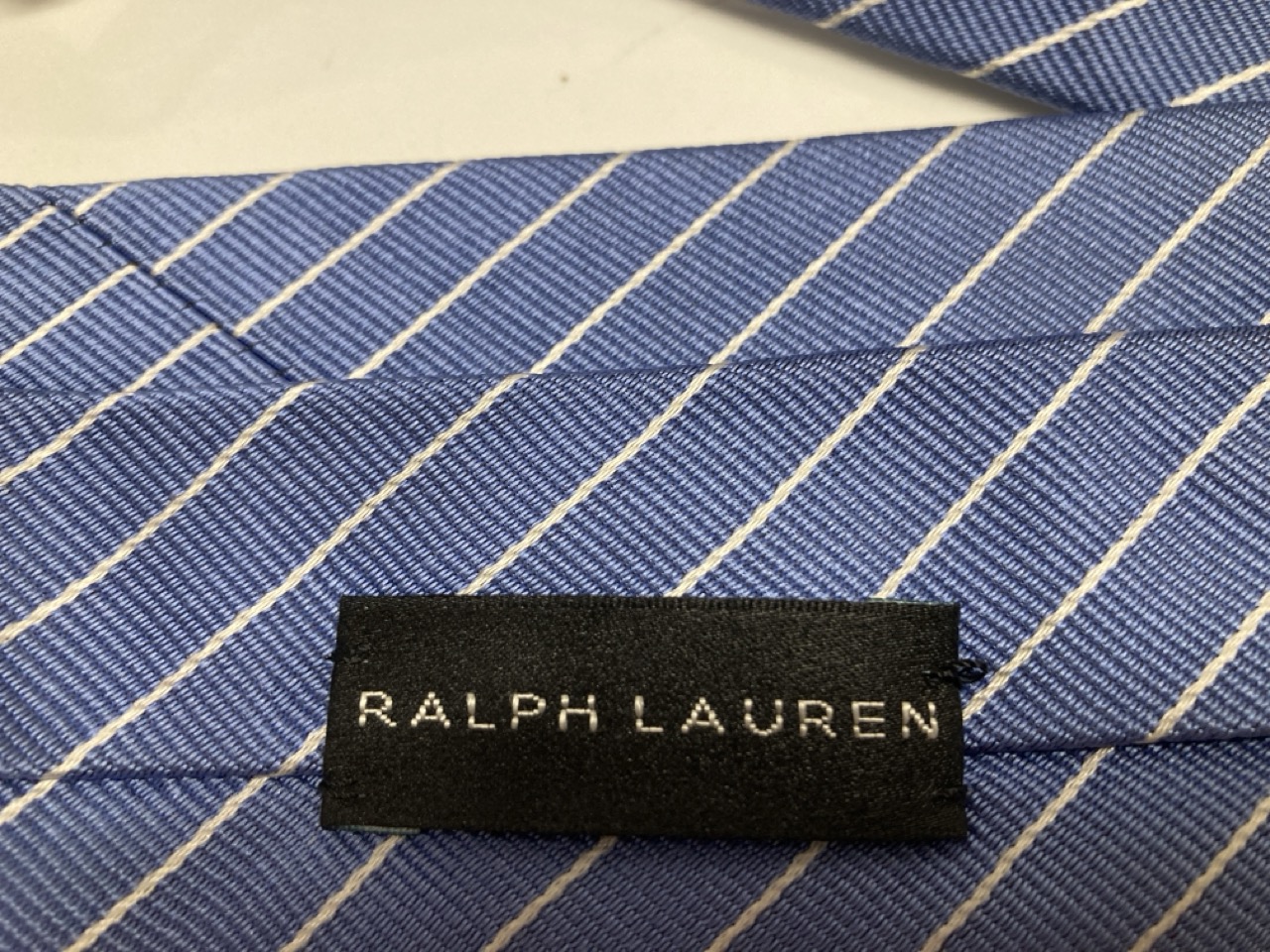 Lot 245  
            Edinburgh SR20 - Delivery Only 

                
RALPH LAUREN STRIPE FORMAL TIE IN BLUE PRINT SILK: LOCATION - TABLE 1