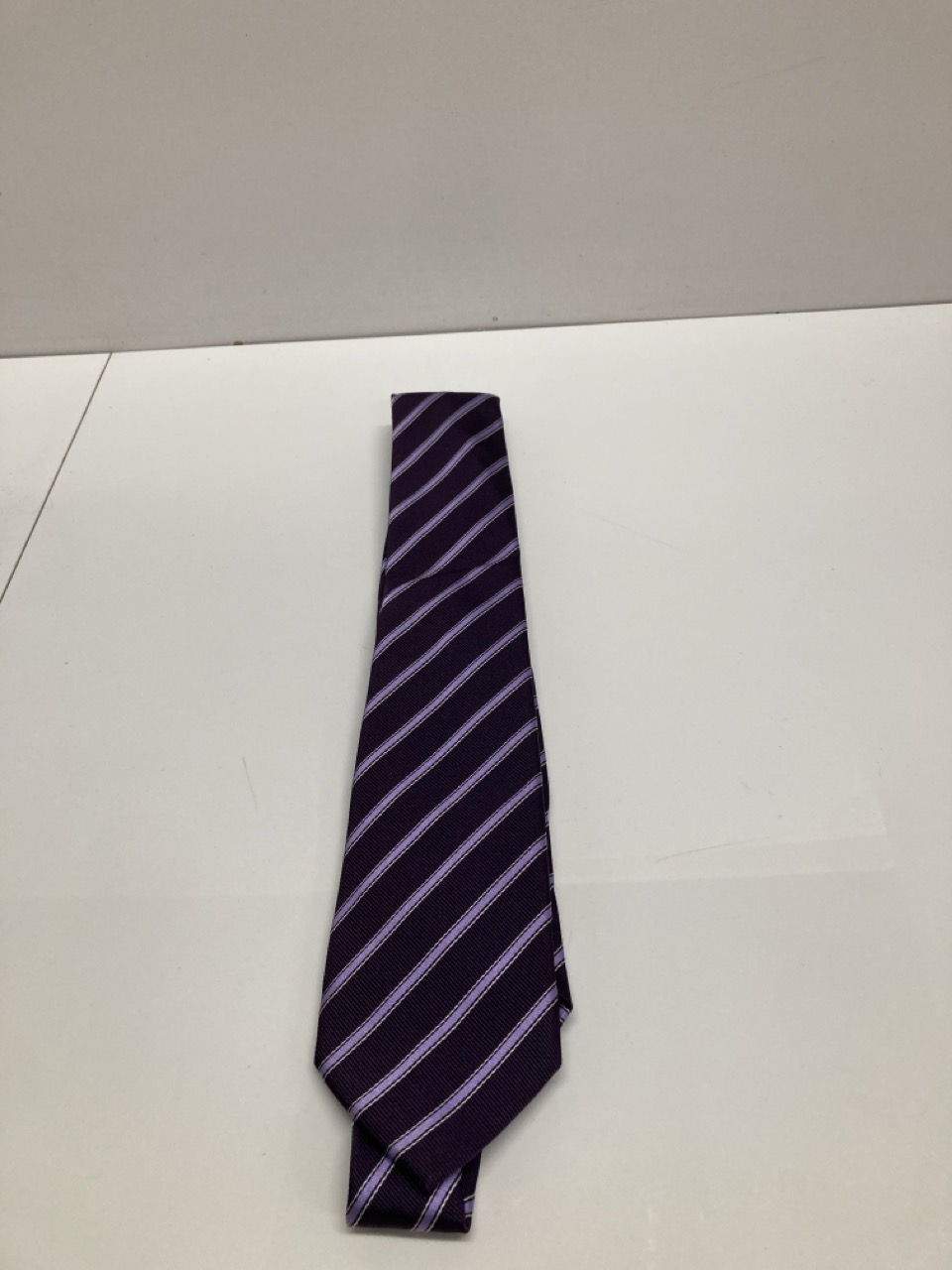 Lot 260  
            Edinburgh SR20 - Delivery Only 

                
CHURCH'S STRIPE FORMAL TIE IN PURPLE PRINT SILK : LOCATION - TABLE 1
