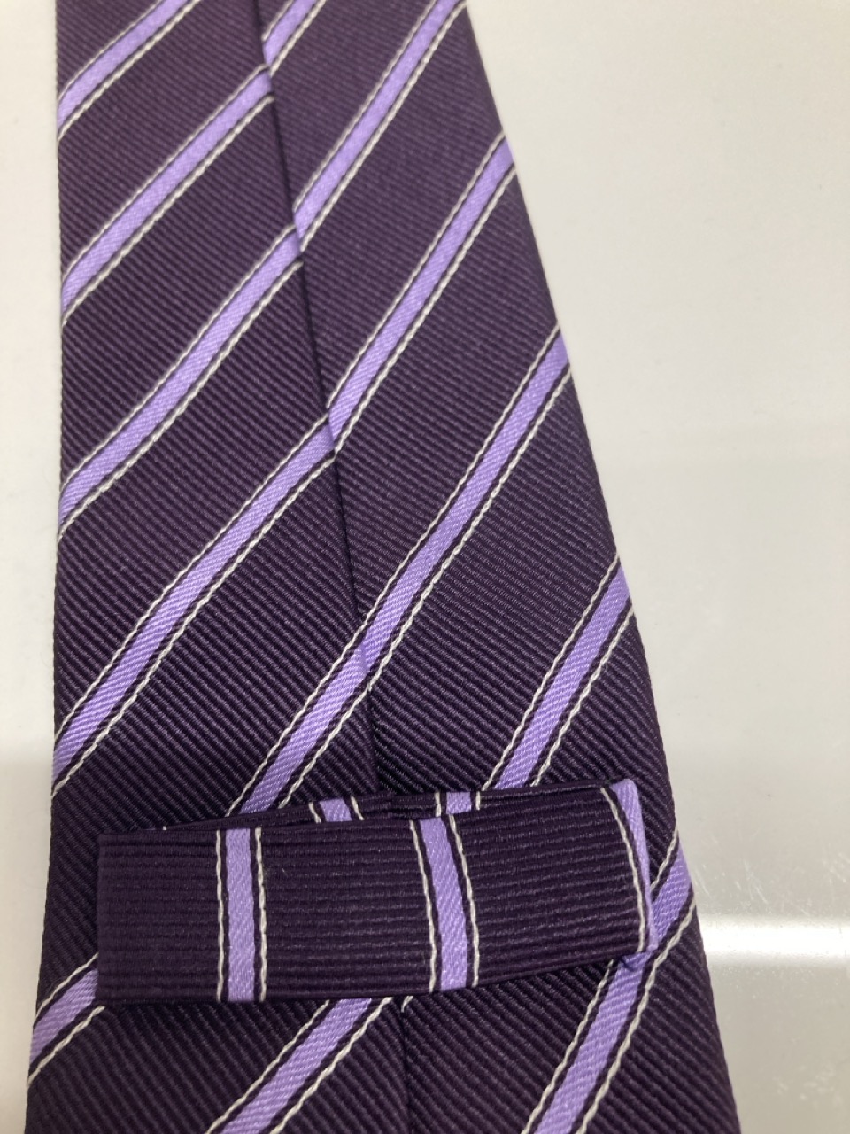 Lot 260  
            Edinburgh SR20 - Delivery Only 

                
CHURCH'S STRIPE FORMAL TIE IN PURPLE PRINT SILK : LOCATION - TABLE 1