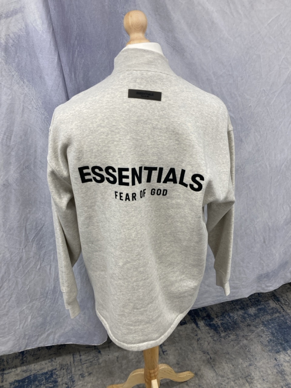 Lot 311  
            Edinburgh SR20 - Delivery Only 

                
FEAR OF GOD ESSENTIALS LOGO-FLOCKED JERSEY MOCK-NECK SWEATSHIRT IN CREAM COTTON S...